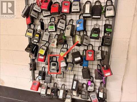 A wall of padlocks with one red one highlighted.