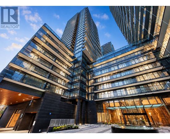 A modern building with glass windows and a sign that reads "Dream On Realty.".