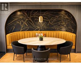 A modern dining area with a round table and four chairs.