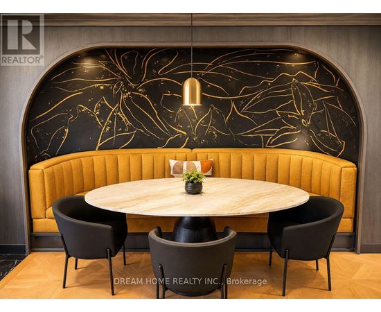 A modern dining area with a round table and four chairs.