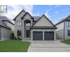 A large, two-story house with a garage is for sale.