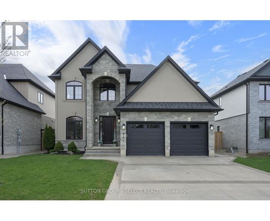 A large, two-story house with a garage is for sale.