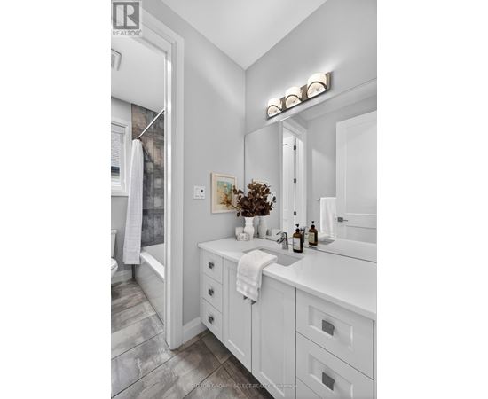 A bathroom with a white sink and a white towel.