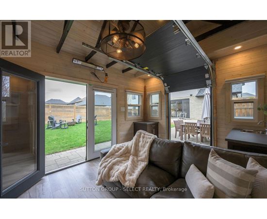 A living room with a couch and a ceiling fan.