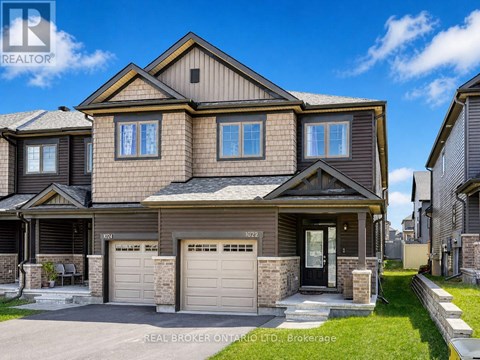 A large, two-story house with a garage is for sale.