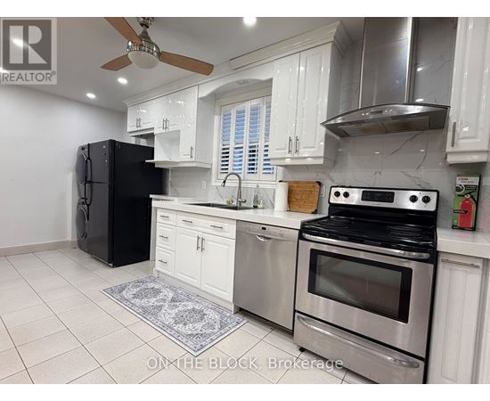 A modern kitchen with stainless steel appliances and white cabinets.