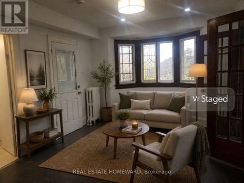 A living room with a couch, chair, and a table with a candle on it.