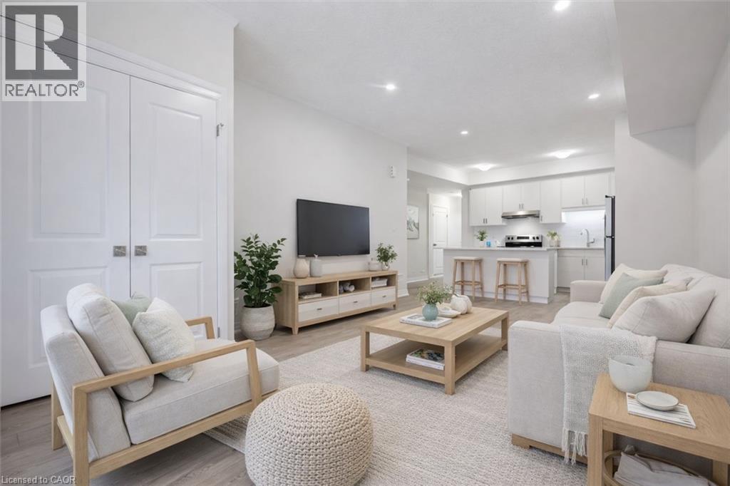 A well-lit living room with a white sofa, a wooden coffee table, and a television.