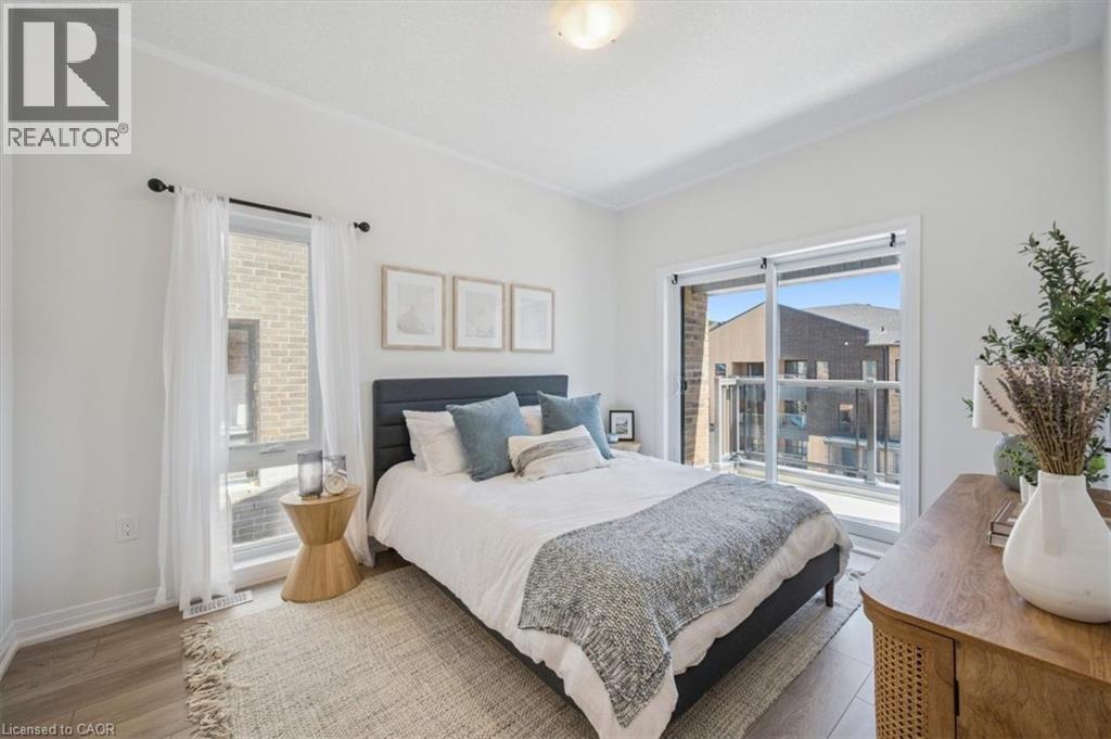 A bedroom with a large bed and a view of a balcony.