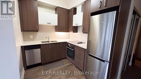 A kitchen with wooden cabinets and stainless steel appliances.