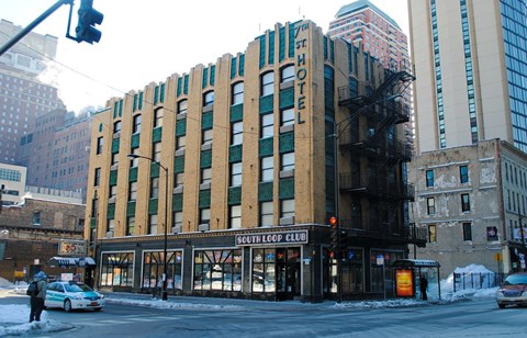 A building with a sign that says South Loop Club.