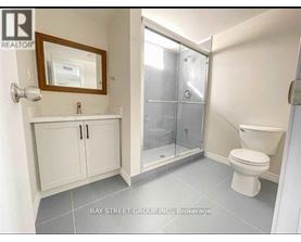 A white bathroom with a toilet, sink, and medicine cabinet.