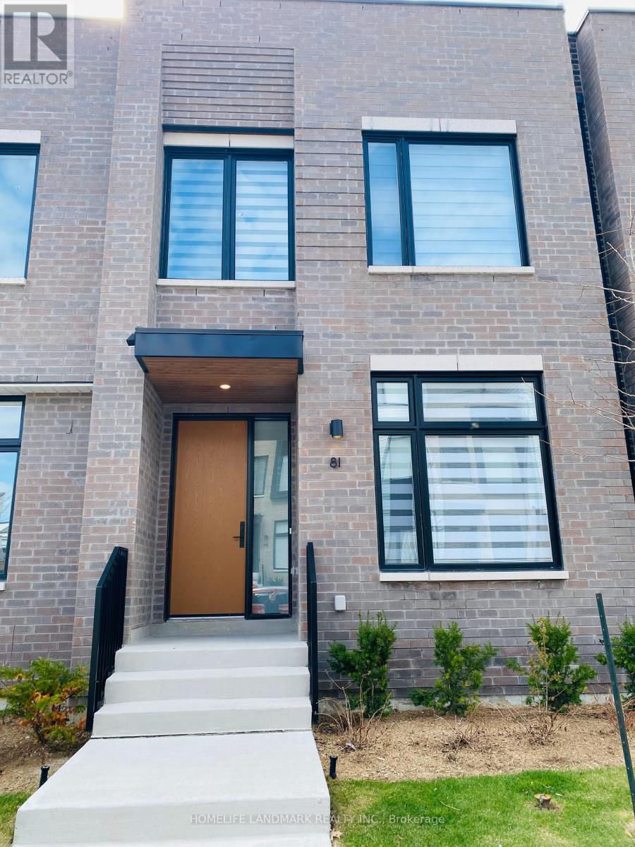 A modern brick building with a wooden door and windows.