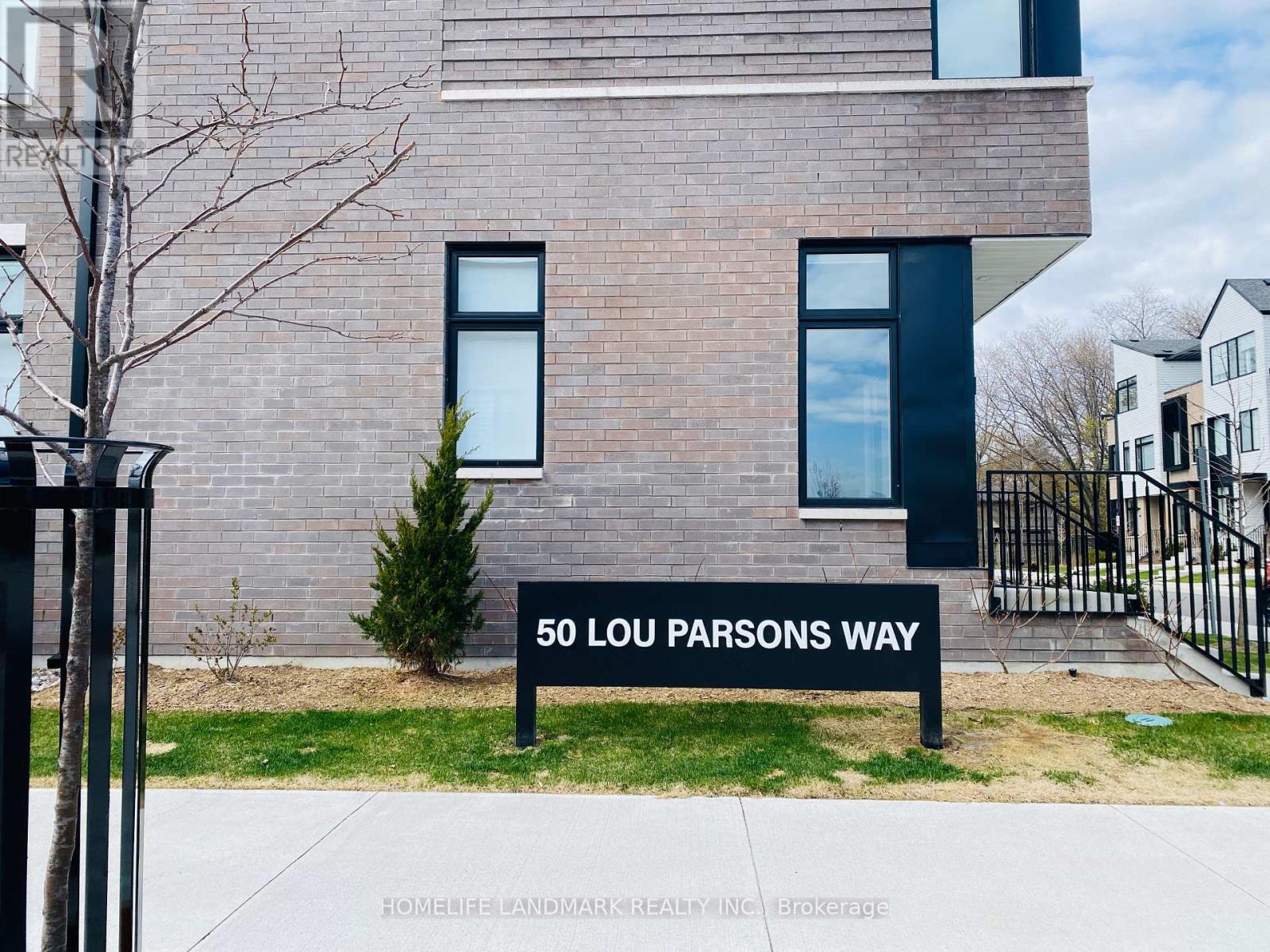 A brick building with a sign that says 50 Lou Parsons Way.