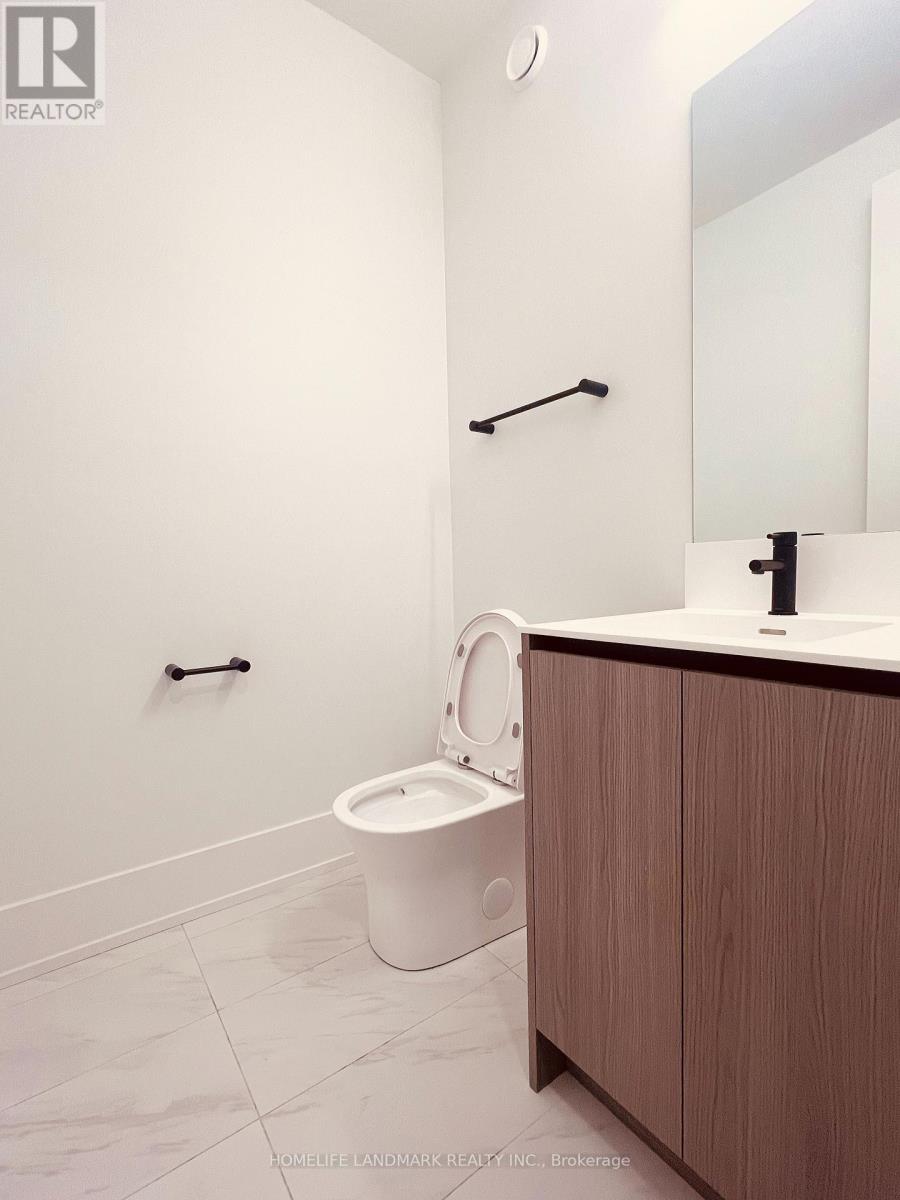 A white toilet with a wooden cabinet and a mirror above it.