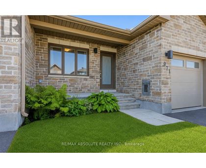 A house with a stone facade and a garage door.