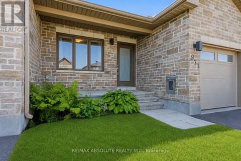 A house with a stone facade and a garage door.