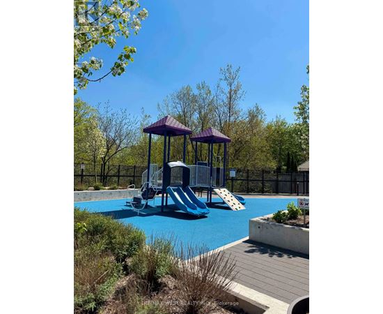 A playground with a purple structure and a slide.