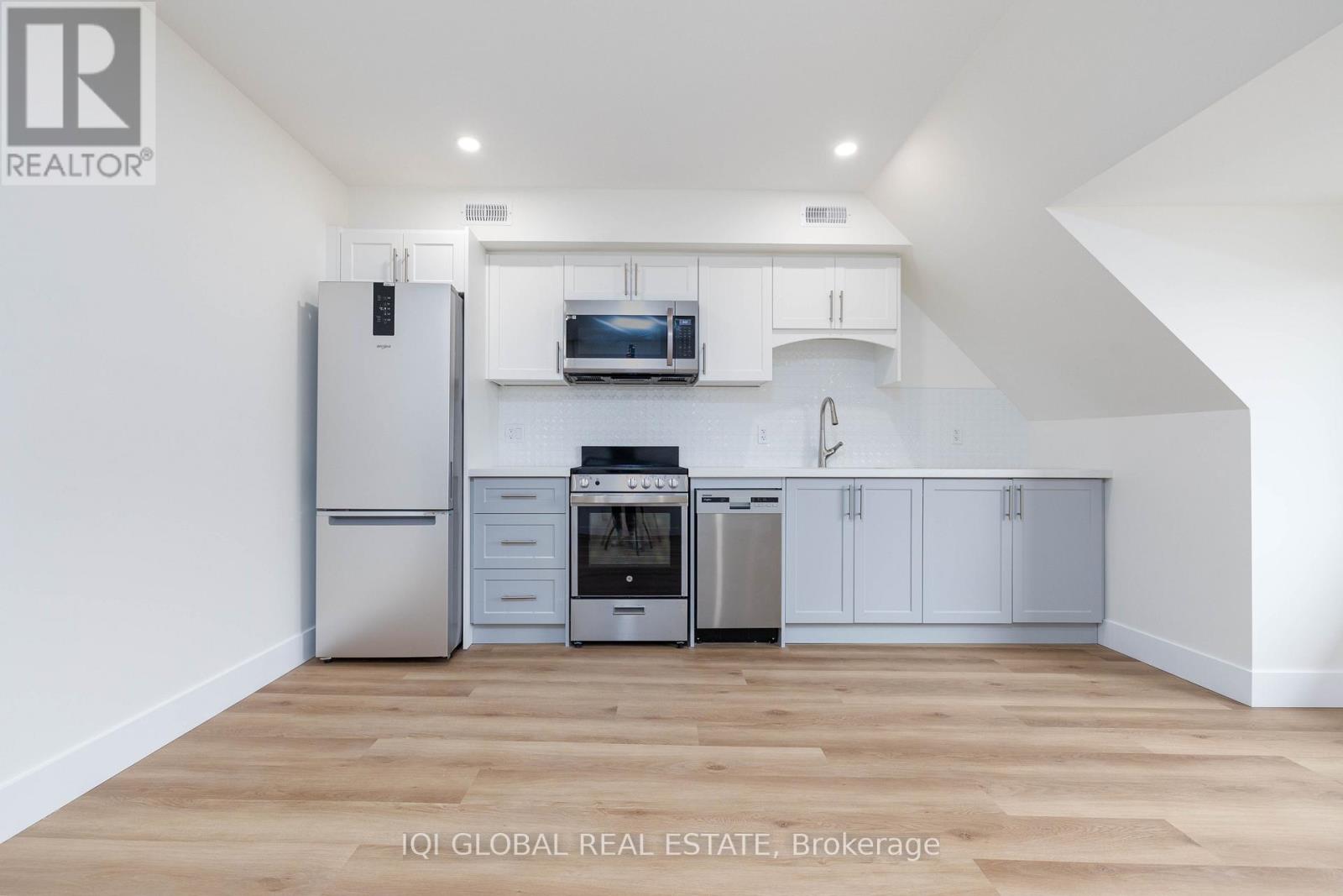 A kitchen with white cabinets and stainless steel appliances.