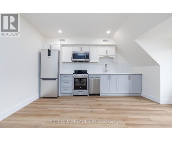 A kitchen with white cabinets and stainless steel appliances.