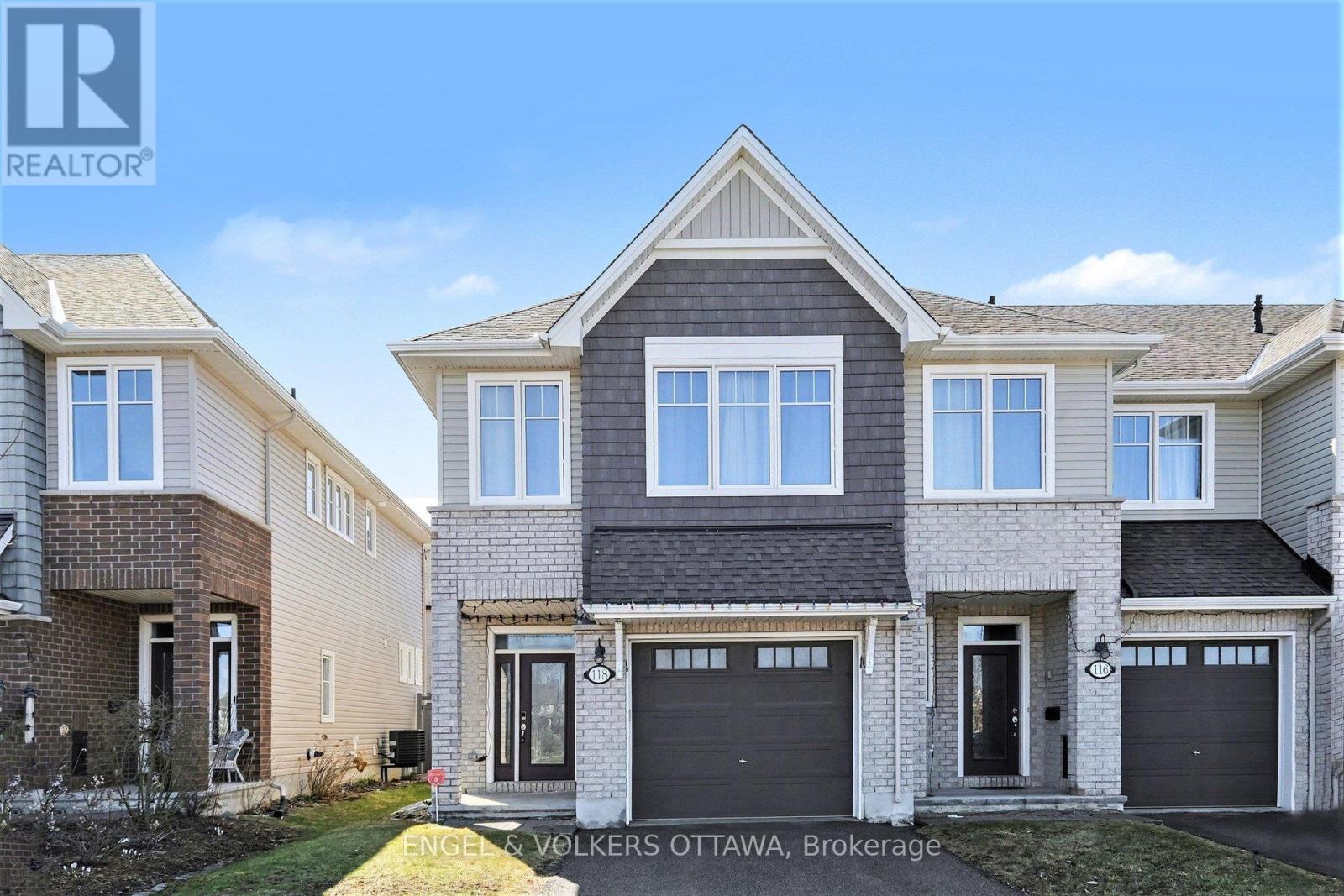 A house with a grey roof and a sign that says "REALTOR" in the top left corner.