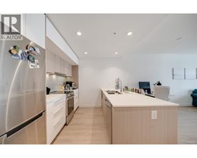 A modern kitchen with a stainless steel refrigerator and wooden cabinets.