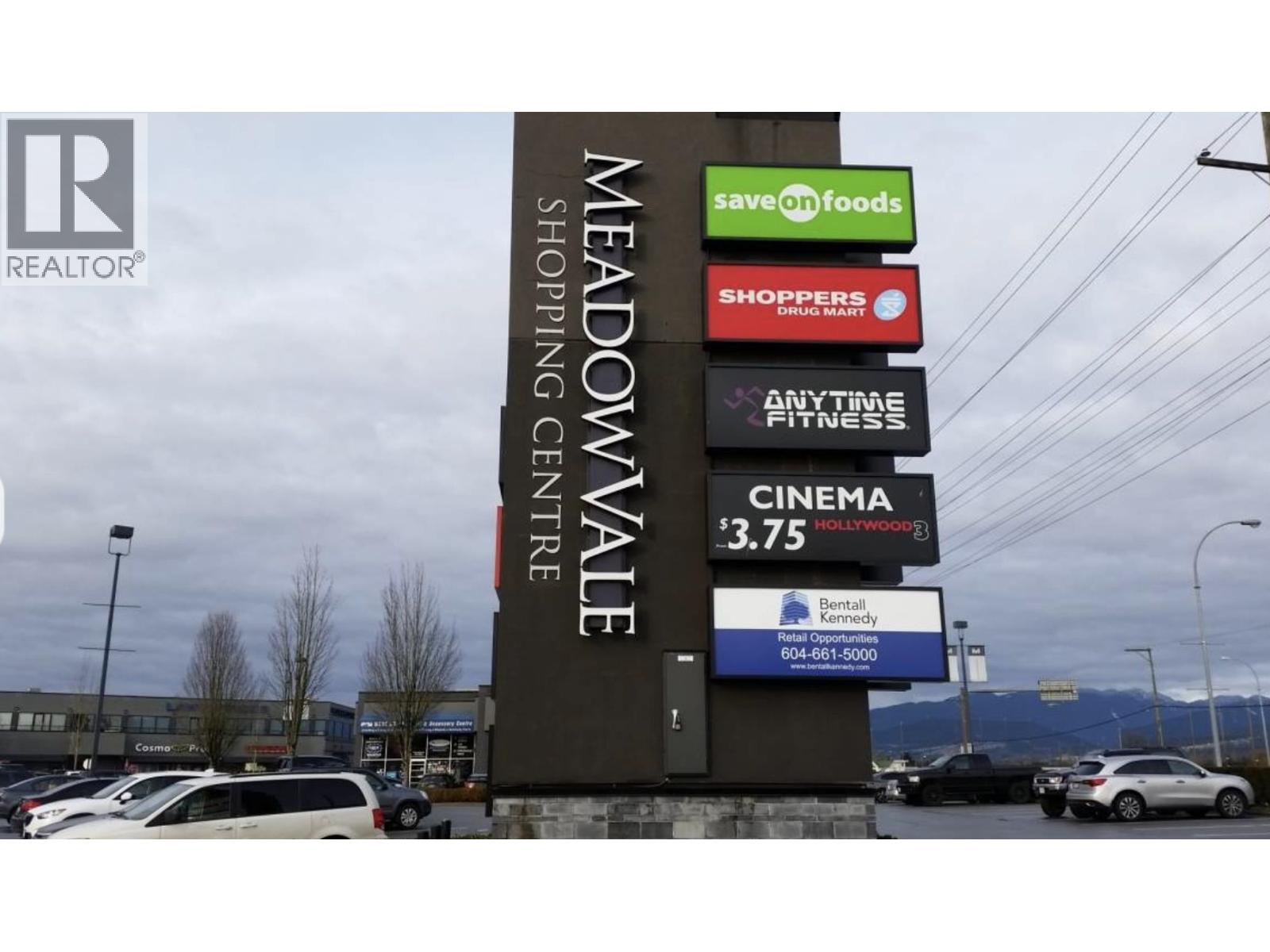 A sign for Meadowvale Shopping Centre with various businesses listed.