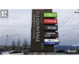 A sign for Meadowvale Shopping Centre with various businesses listed.