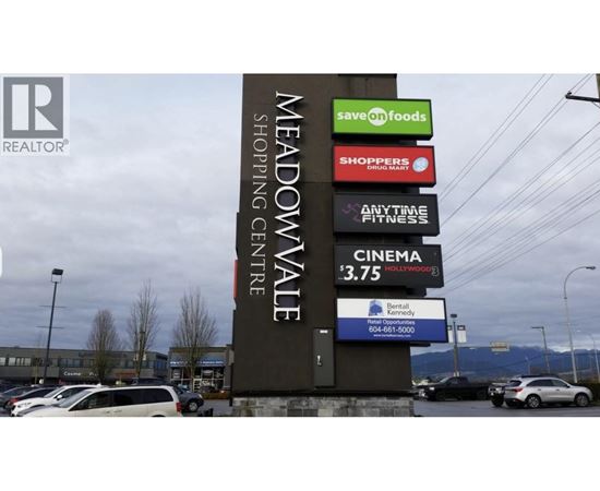 A sign for Meadowvale Shopping Centre with various businesses listed.