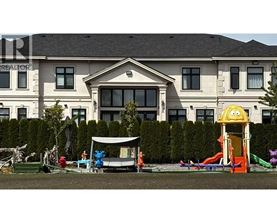 A playground with a slide and a slide in front of a large house.