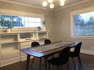 A dining room with a table and chairs.