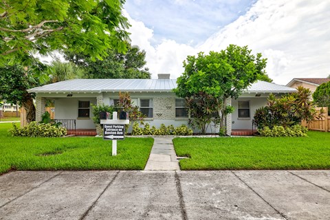 A house with a sign in front of it.