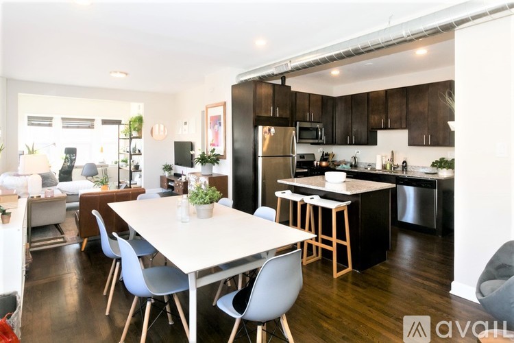 A modern kitchen with a dining table and chairs.