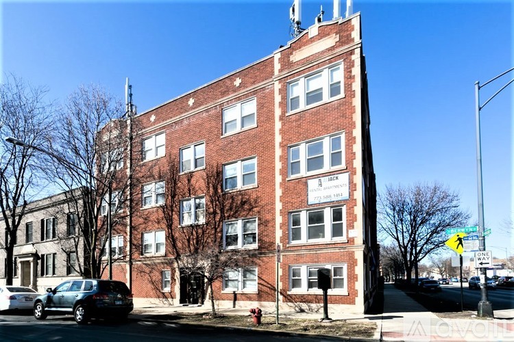 A red brick building with a sign that says "Apartments" on the front.