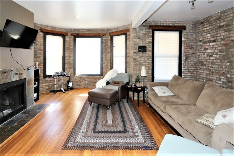 A living room with a fireplace and a couch.