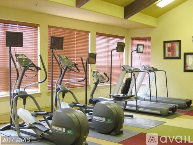A gym with exercise equipment and windows.