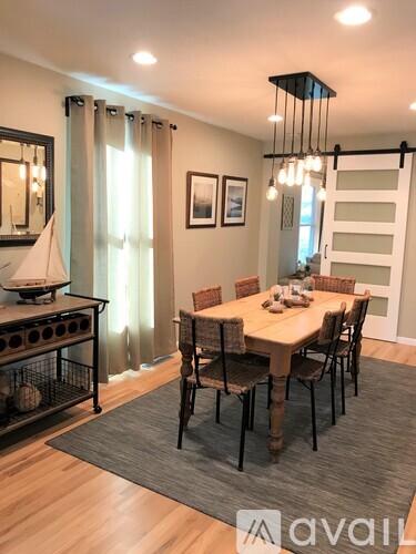 A dining room with a table set for six.
