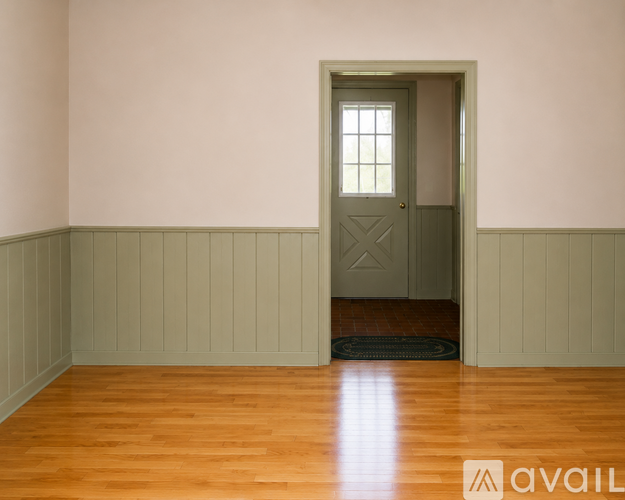 A room with a window and a chair.