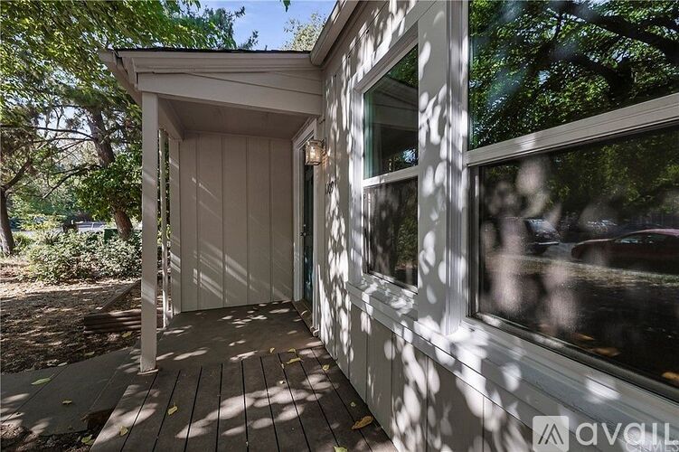 A house with a porch and a window is for sale.