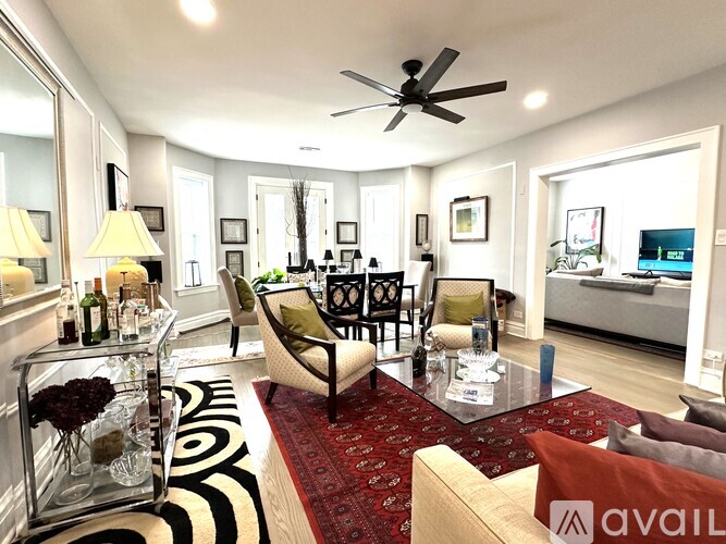 A living room with a glass table and a sofa.