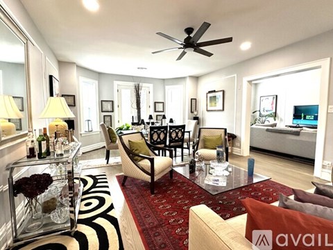 A living room with a glass table and a sofa.