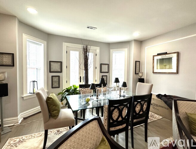 A dining room with a glass table and chairs.