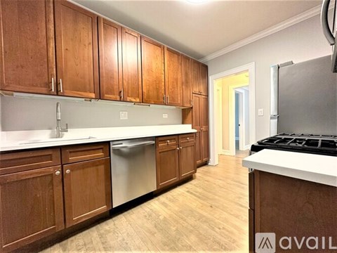 A kitchen with wooden cabinets and a white countertop.