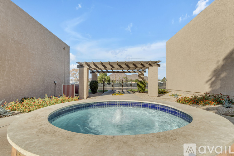 A small pool with a fountain in the middle of it.