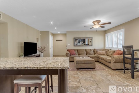 A living room with a brown sofa set and a television.
