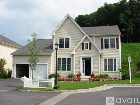 A house with a white picket fence in front.