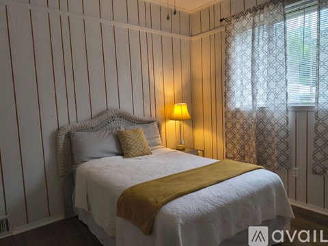 A small white shower stall in a bathroom.