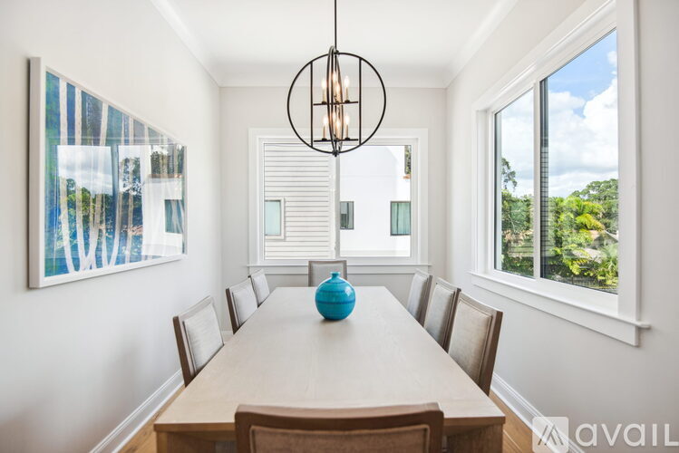 A dining room with a long table and chairs.