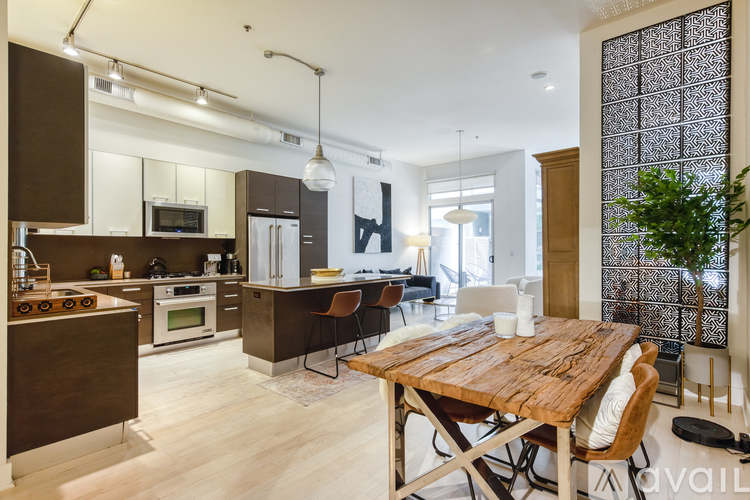 A modern kitchen with a wooden table and chairs.