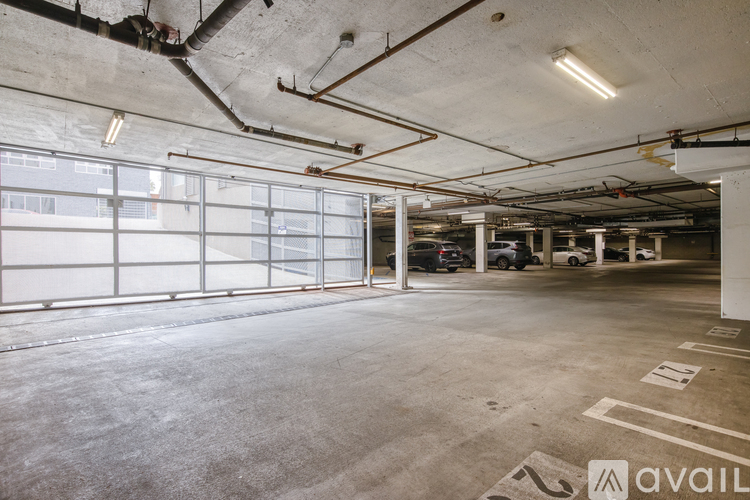 A spacious garage with a concrete floor and white walls.